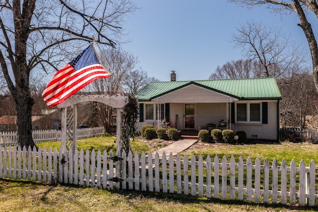 view of front of house featuring a fenced front yard, a porch, metal roof, and a chimney