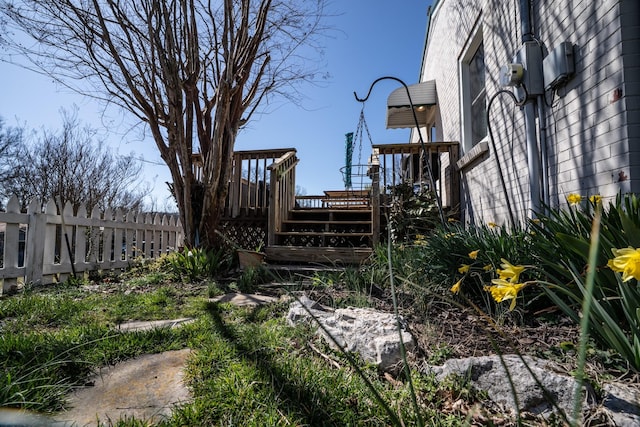 view of yard featuring a wooden deck and fence