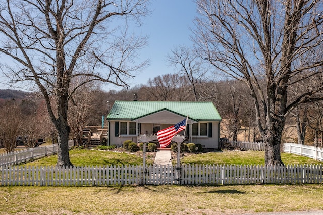 view of front of house featuring a fenced front yard, metal roof, and a front yard