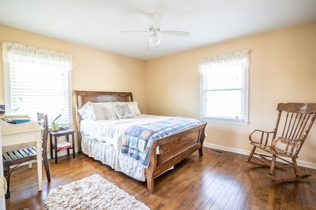 bedroom with visible vents, ceiling fan, dark wood-type flooring, and baseboards