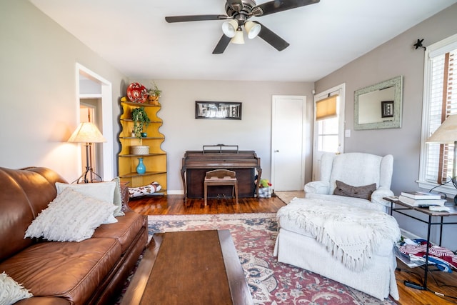 living area with ceiling fan and wood finished floors