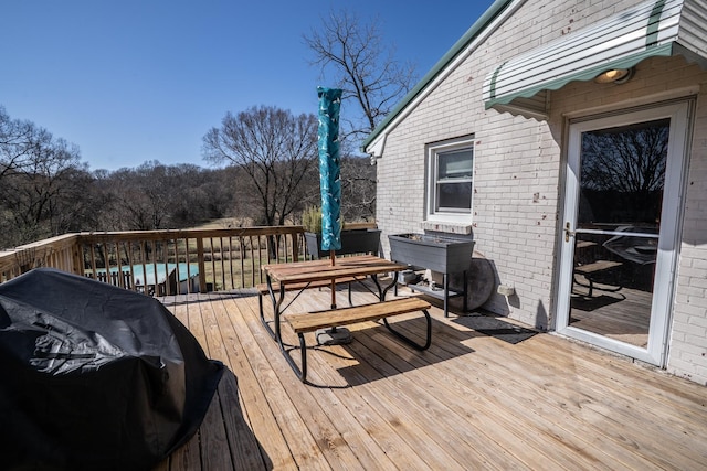 wooden terrace featuring grilling area