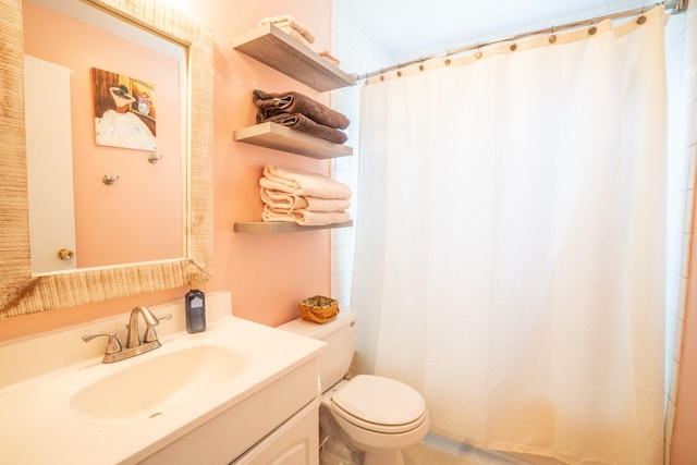 bathroom with vanity, a shower with shower curtain, and toilet