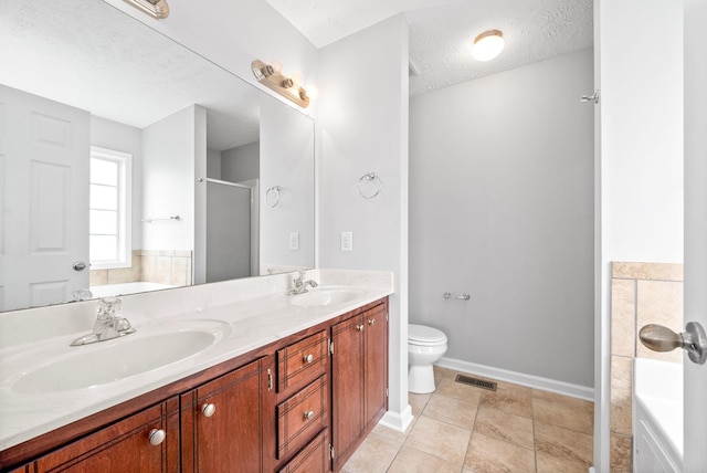 full bathroom with double vanity, visible vents, a textured ceiling, and a sink