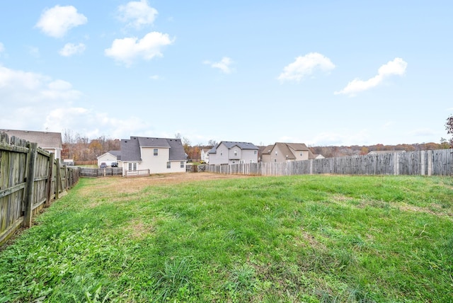 view of yard featuring a residential view and a fenced backyard