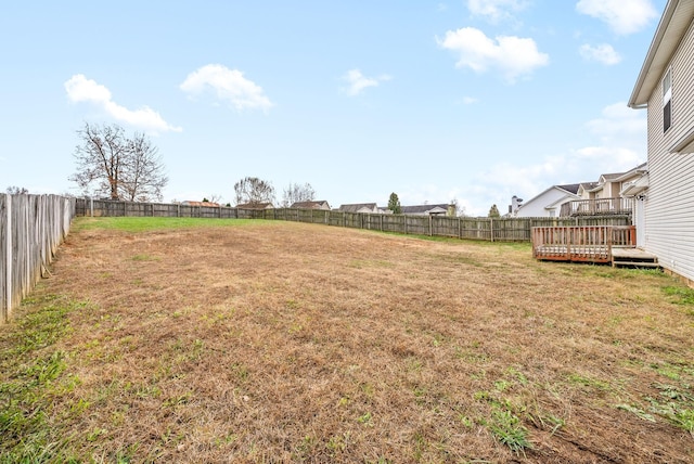 view of yard with a deck and a fenced backyard