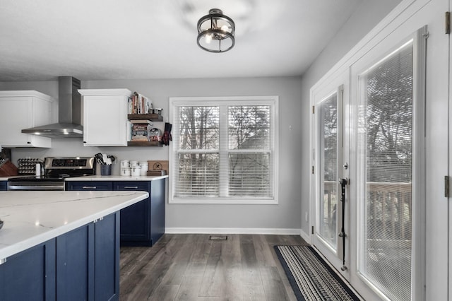 kitchen featuring dark wood-style floors, stainless steel electric range, white cabinets, blue cabinets, and wall chimney exhaust hood