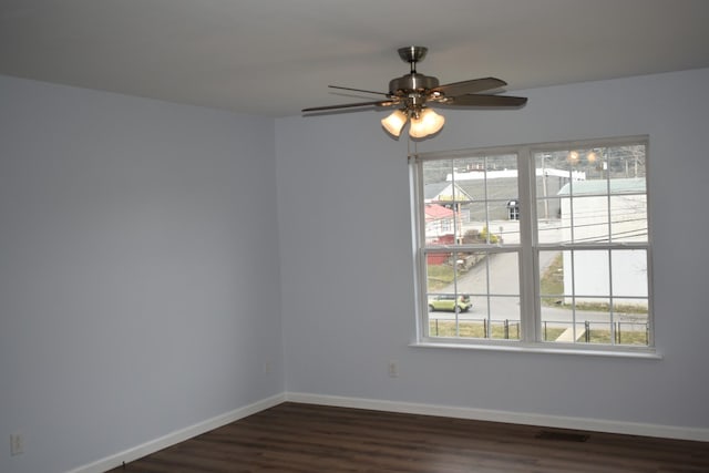 spare room featuring baseboards, a healthy amount of sunlight, and a ceiling fan