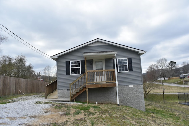 bungalow-style home with fence