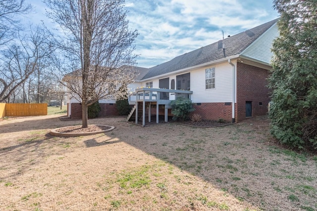 exterior space with stairway, a deck, and fence