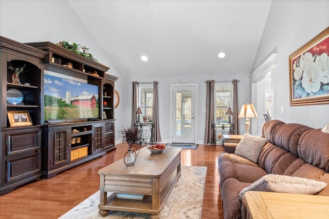 living area featuring plenty of natural light, wood finished floors, recessed lighting, and baseboards