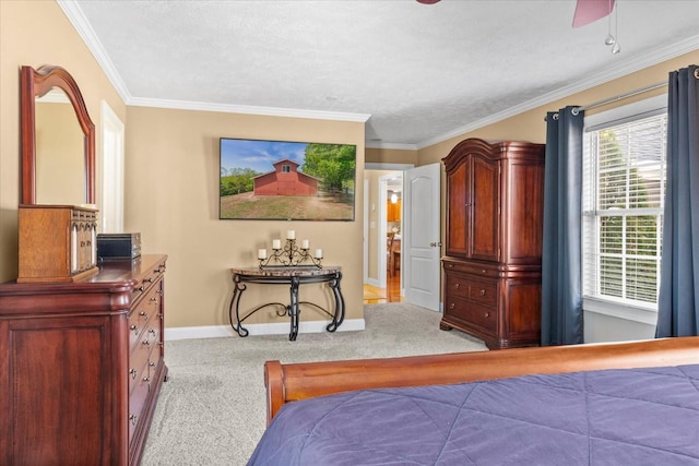 carpeted bedroom with baseboards, a ceiling fan, and crown molding