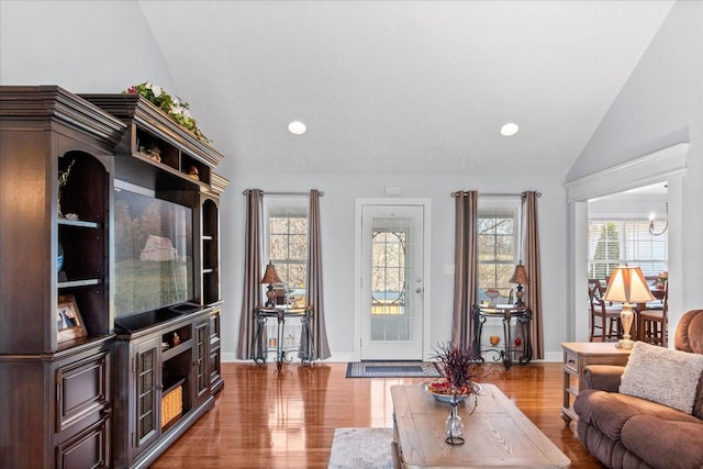 living room featuring recessed lighting, light wood finished floors, and vaulted ceiling