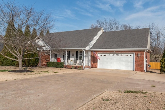 single story home featuring brick siding, a shingled roof, concrete driveway, covered porch, and a garage