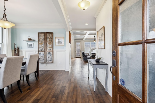 foyer entrance featuring dark wood-style floors, coffered ceiling, wainscoting, crown molding, and beamed ceiling