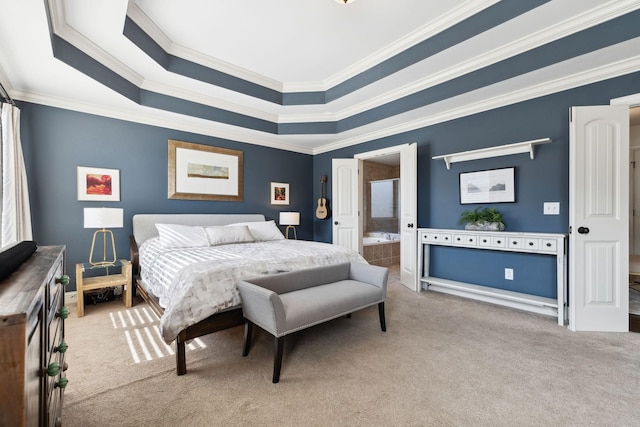 carpeted bedroom featuring a raised ceiling, ensuite bath, and ornamental molding