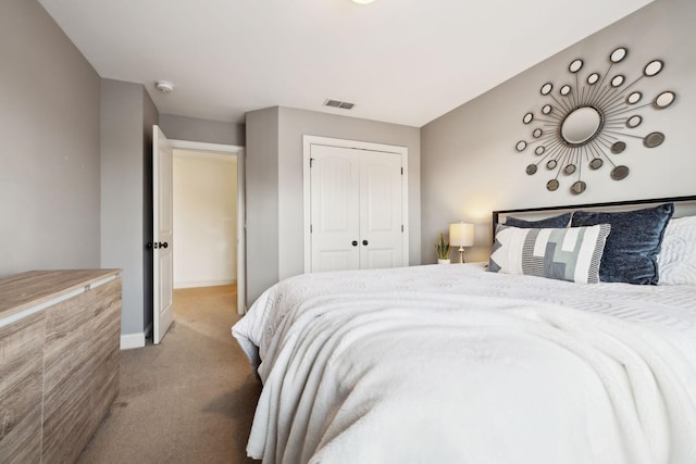 bedroom featuring light colored carpet, visible vents, a closet, and baseboards