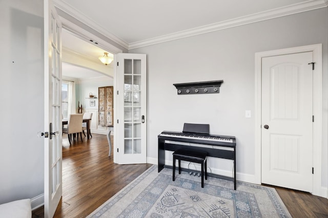 sitting room featuring french doors, baseboards, wood finished floors, and ornamental molding