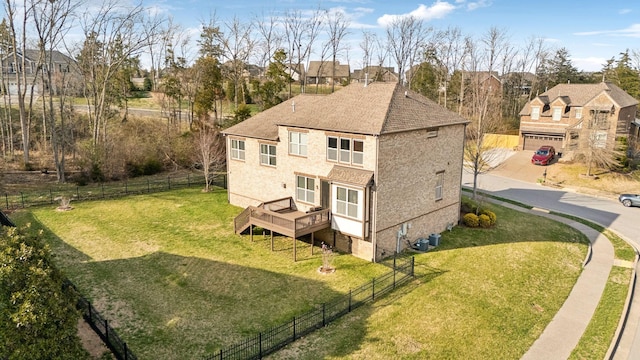 exterior space featuring a wooden deck, central air condition unit, a lawn, and fence