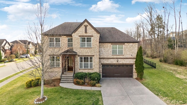 view of front of house with brick siding, driveway, an attached garage, and a front yard