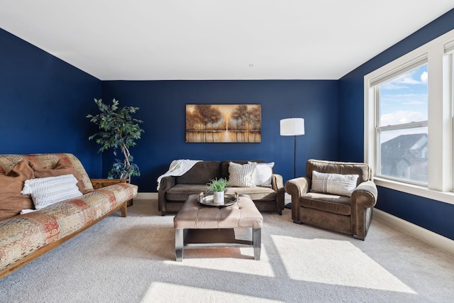 carpeted living room featuring baseboards