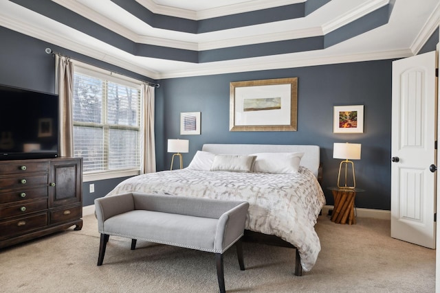 bedroom with a tray ceiling, baseboards, and carpet