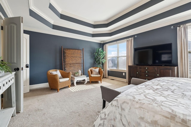 carpeted bedroom with baseboards, a raised ceiling, and crown molding