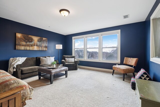 carpeted living room with baseboards and visible vents