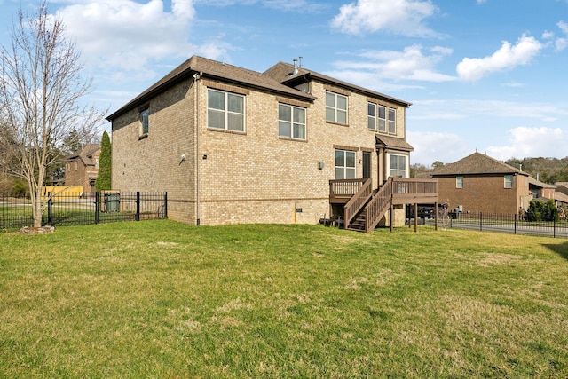 back of house featuring brick siding, a wooden deck, a lawn, a fenced backyard, and crawl space