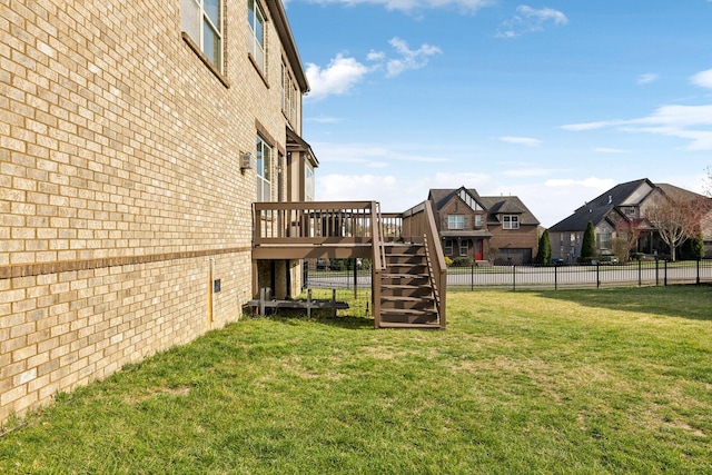 view of yard featuring a residential view, stairs, a deck, and fence