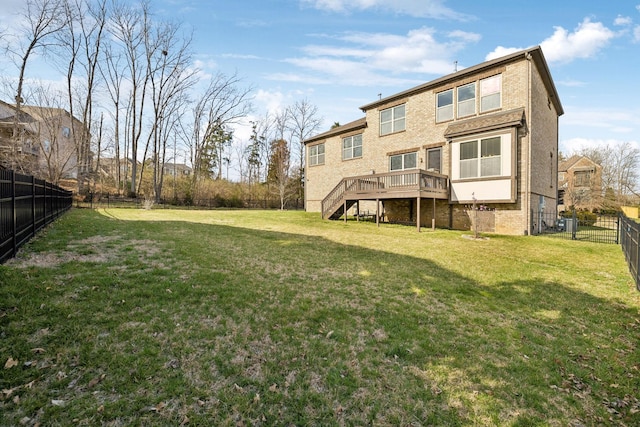 rear view of property with a wooden deck, stairway, a yard, and a fenced backyard