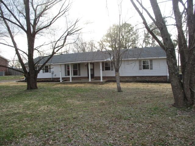 ranch-style home with a porch and a front yard