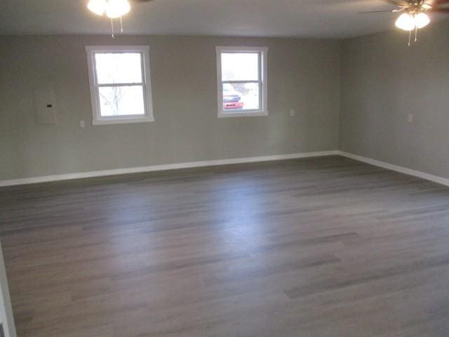 spare room featuring baseboards, a healthy amount of sunlight, and ceiling fan