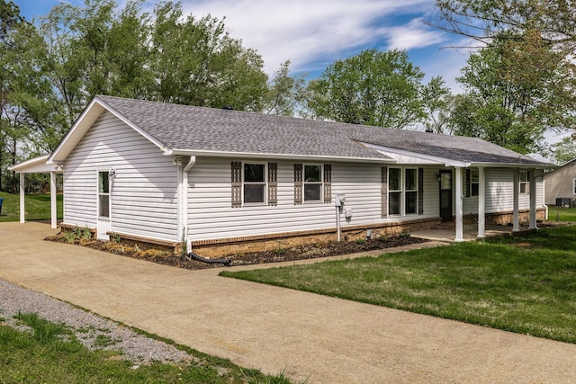 ranch-style house with a front lawn and roof with shingles