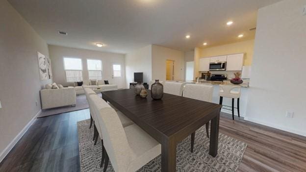 dining space featuring recessed lighting, baseboards, and dark wood-style flooring