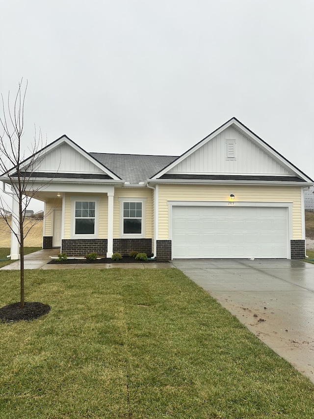 view of front facade with central AC unit, driveway, a front lawn, a garage, and brick siding