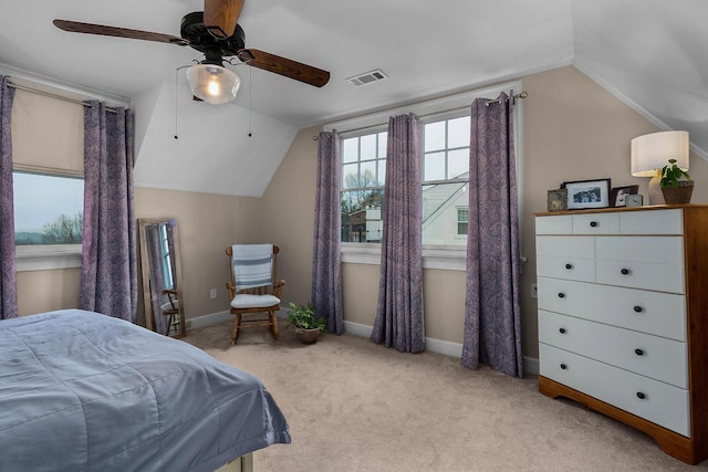 carpeted bedroom featuring visible vents, baseboards, ceiling fan, and vaulted ceiling