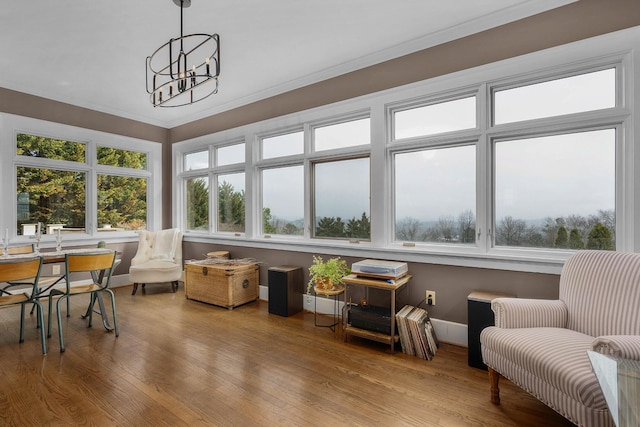 sunroom / solarium with a notable chandelier