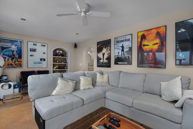 living room featuring built in features and a ceiling fan