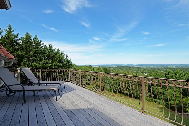 wooden deck featuring a view of trees