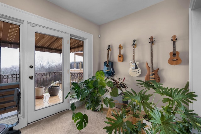 doorway to outside featuring carpet floors