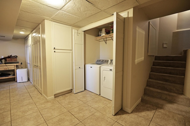 washroom featuring light tile patterned floors, separate washer and dryer, and baseboards