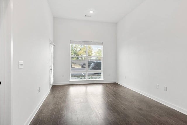 unfurnished room featuring recessed lighting, visible vents, baseboards, and dark wood-type flooring