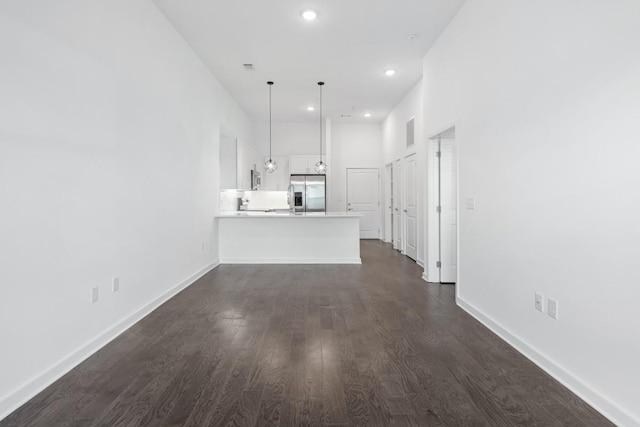 unfurnished living room featuring dark wood-style floors, visible vents, recessed lighting, and baseboards