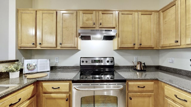 kitchen featuring dark stone countertops, stainless steel electric range, exhaust hood, and light brown cabinetry