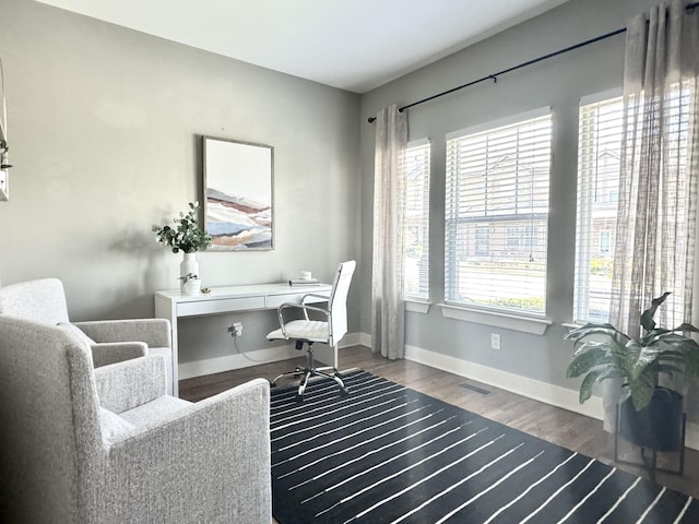 office space featuring visible vents, baseboards, and wood finished floors