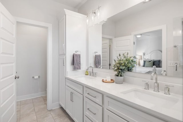 bathroom with double vanity, connected bathroom, ceiling fan, and a sink