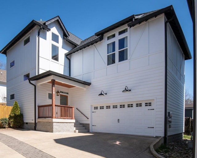 view of front facade with crawl space, a garage, and driveway