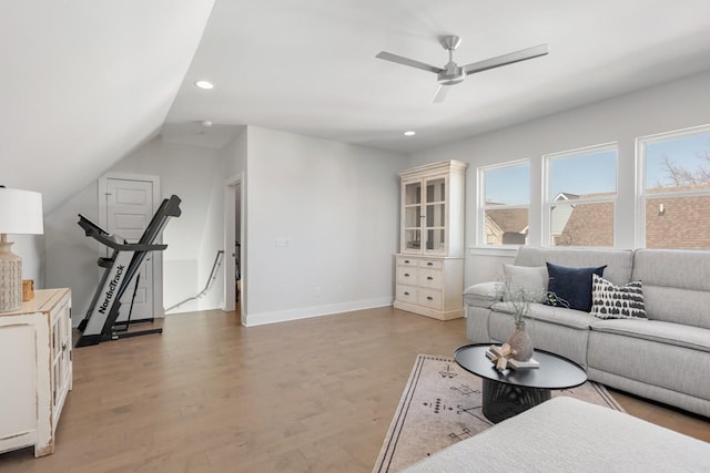 living room featuring recessed lighting, a ceiling fan, light wood-style floors, and baseboards