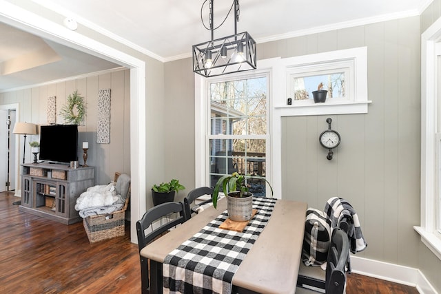 dining room with dark wood-type flooring, baseboards, a chandelier, and ornamental molding